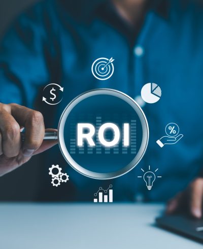 Analyzing,Return,On,Investment,(roi),Concept.,Businessman,Holding,A,Magnifying