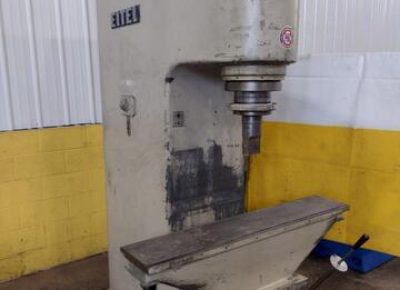 old Eitel press A well-used legacy model Eitel manual straightening press sits against a white and yellow background.